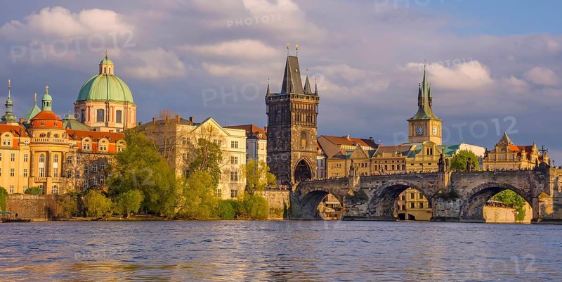 Charles Bridge (Karluv Most) on Vltava river and Old Town Bridge Tower, famous tourist destination in Prague, Czech Republic (Czechia), at sunset