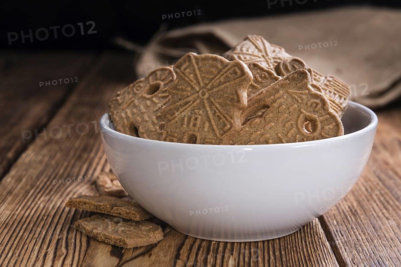 Heap of fresh baked Spekulatius (German cuisine) on wooden background