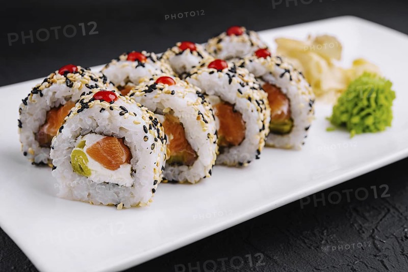Food, Delicious sushi rolls with salmon, avocado, and sesame seeds served on a sleek plate, garnished with wasabi and ginger