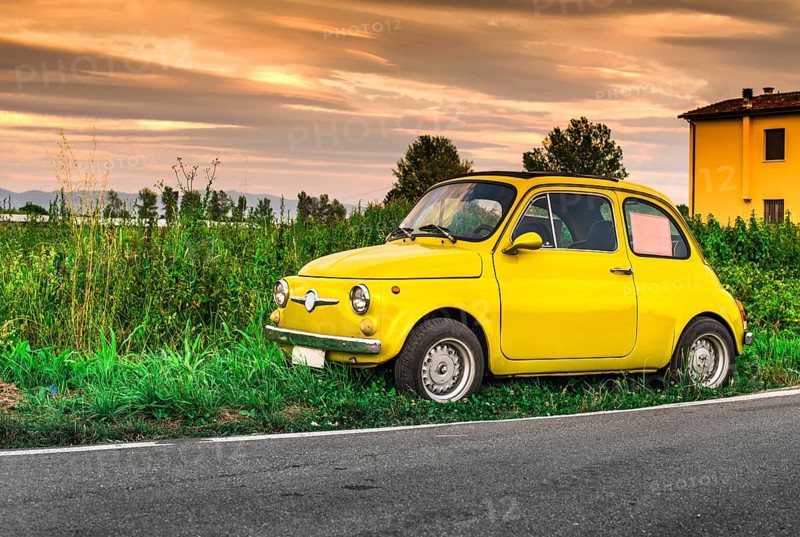 Small vintage italian car Fiat Abarth. Yellow color
