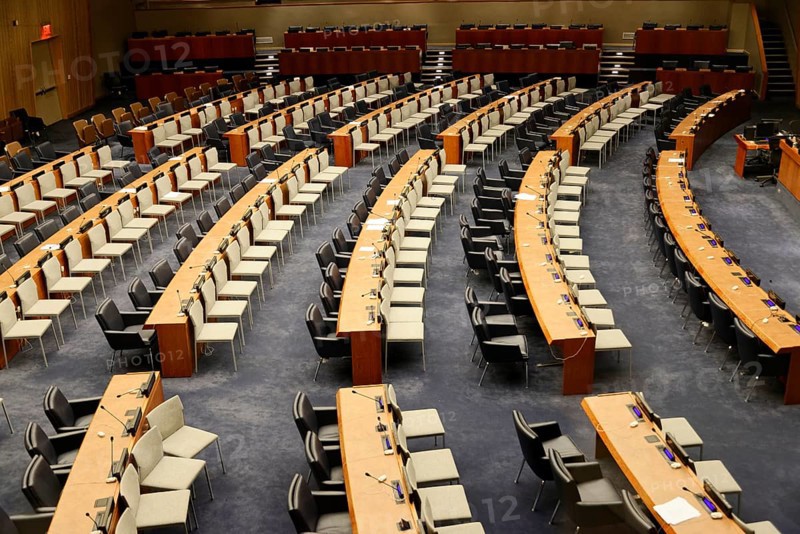 UN Headquarters, East River, Manhattan, An avenue of flags of the member states of the United Nations next to a street, New York City, New York, USA, Large empty conference room with orderly seating arrangement, North America