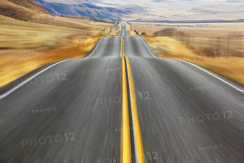 A Mirage on high speed. Magnificent American road and fencings on roadsides from snow drifts
