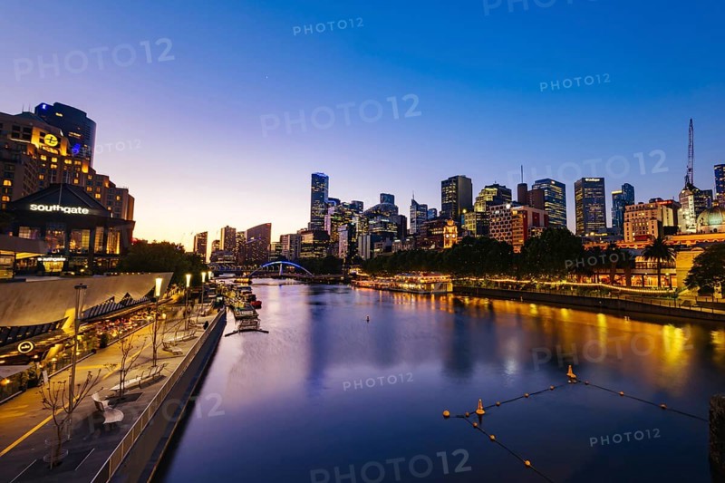 MELBOURNE, AUSTRALIA - OCTOBER 10, 2024: Melbourne skyline from Princes Bridge in Southbank along the Yarra River at dusk in Victoria, Australia