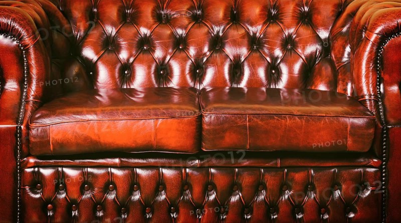 Red Genuine Leather Sofa Near The Wall