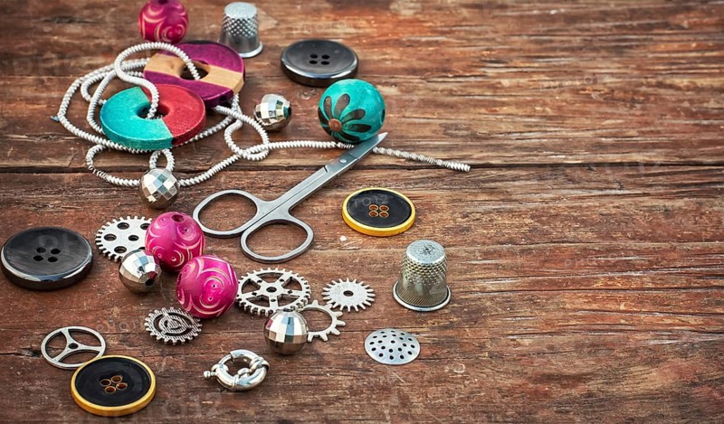 Beads and jewellery for handmade on light orange plate