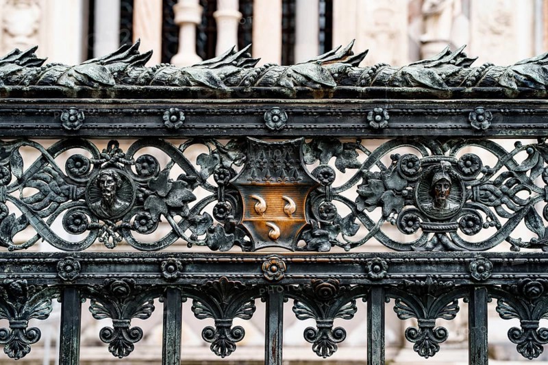 Forged metal fence near the Duomo Cathedral. Milan, Italy.