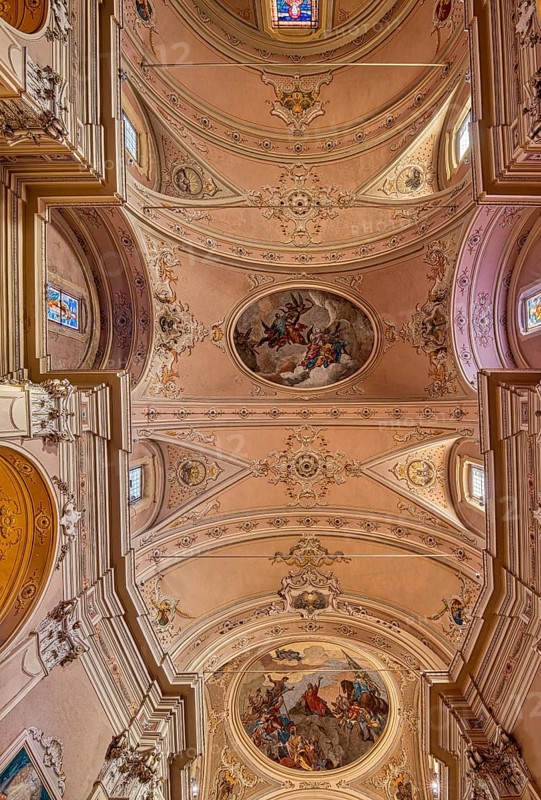 Stucco ceiling with frescoes in the catholic church of Santo Stefano