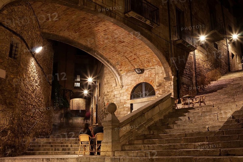 Arch of the Agullana Palace and Sant Domenec stairs at night in Girona, Catalonia, Spain