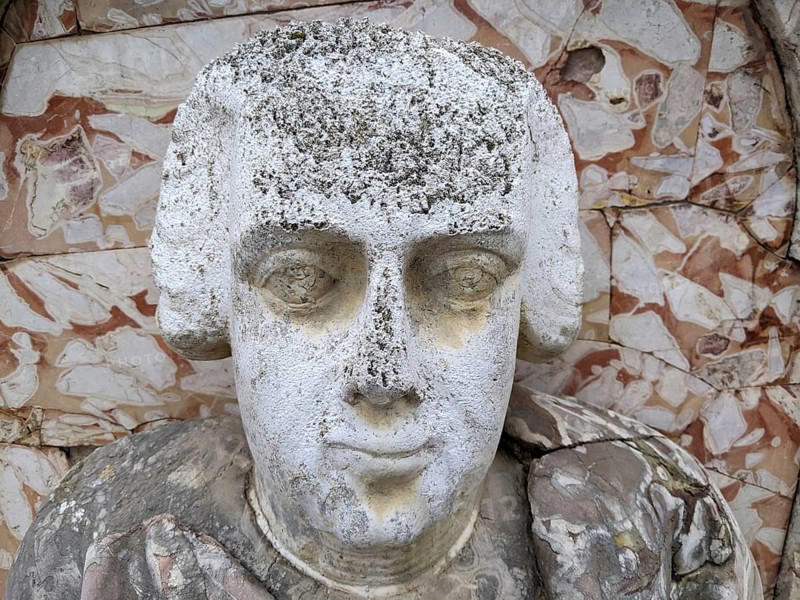 Weathered stone bust with classical features and detailed carving against a textured background, Villa Palagonia, known as the ‘villa of monsters', is an 18th-century walled building located in Bagheria, Sicily