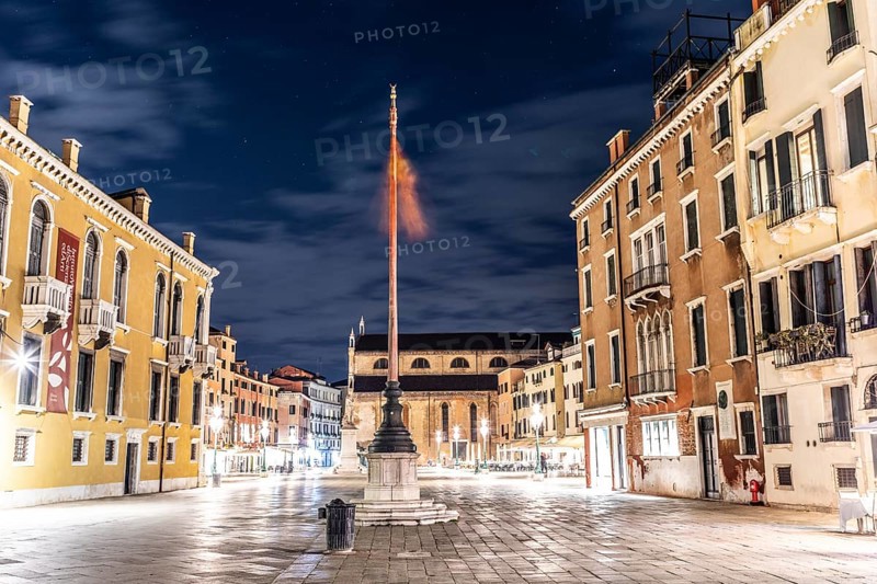 Venetian flag waving in the wind, illuminated facades, Campo Santo Stefano, night shot, Venice, Italy