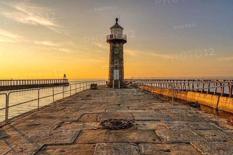 Golden Hour at the East Pier and Whitby East Harbour Lighthouse in Whitby, North Yorkshire, England, UK