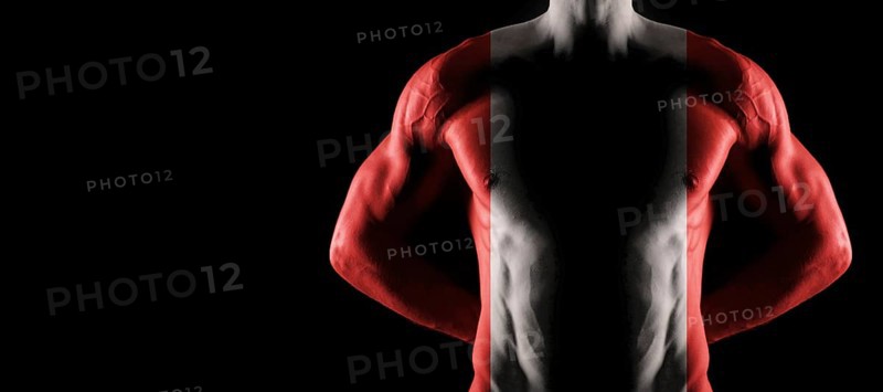 Peru flag on muscled male torso with abs, black background
