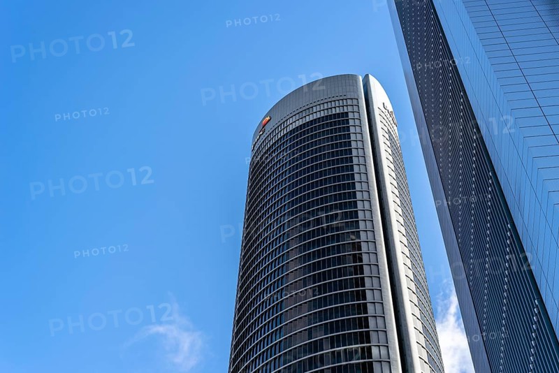 Madrid, Spain, May 10, 2020: Low angle view of office building in the city of Madrid against blue sky. PWC building in Cuatro Torres financial district