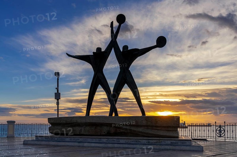 Taranto, Italy, 30 November, 2023: view of the Sailor Monument at the harbor entrance of Taranto at sunset