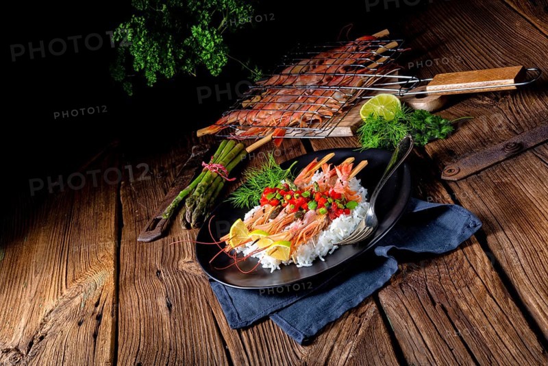 Grilled red argentine shrimps with red salsa and green asparagus