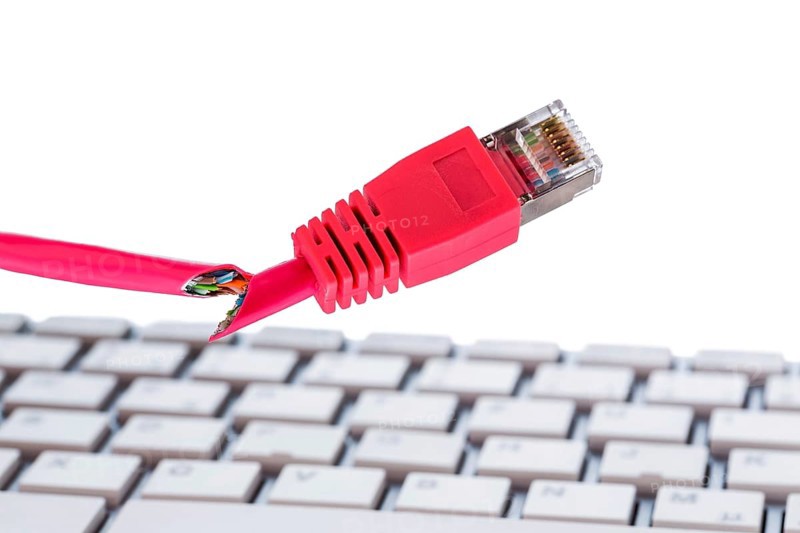 Defective network cable on keyboard, symbol photo for online, networks, malfunction and espionage