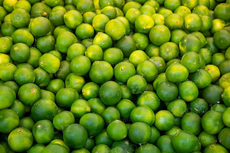 Freshly picked green tangerines mandarines, clementines, as Citrus fruit background