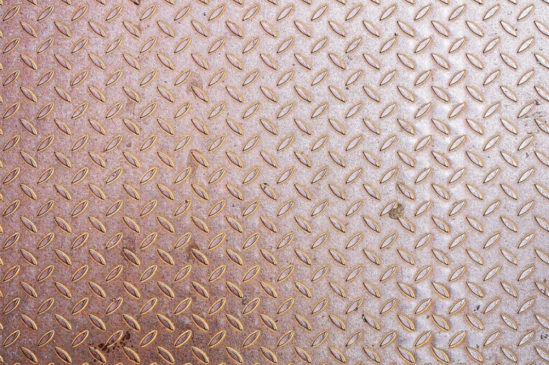 An image of a rusty diamond metal plate background