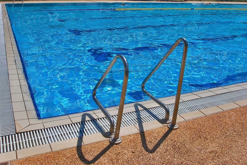 Pool with pure transparent water and hand-rail of descent