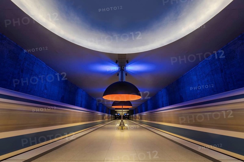 Futuristic underground railway tunnel with blue and yellow lighting, Munich, Bavaria, Germany