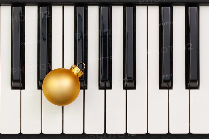 Top view close up shot of piano keyboard and Christmas decoration. Flat Lay Image
