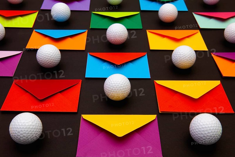 Composition with colored envelopes and golf balls on the table. The photo suitable for various holidays and anniversaries