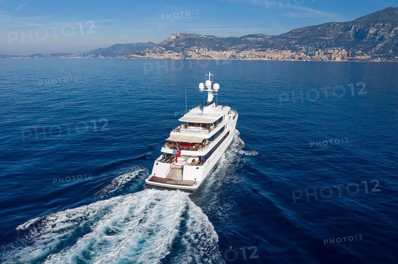 Aerial view 74 metre motor yacht AURORA, delivered in 2017 by the German shipyard Lürssen Yachts, Design Winch Design, sailing past Roquebrune Cap Martin in the morning to the Principality of Monaco, Cote d'Azur, Mediterranean Sea