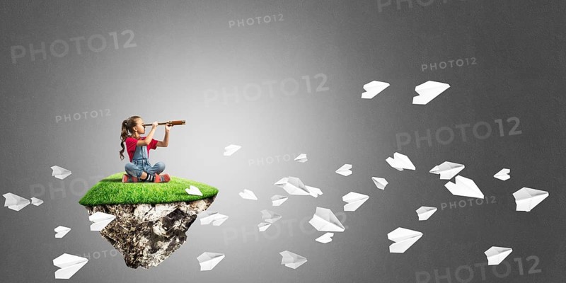Cute kid girl sitting on floating island against concrete background