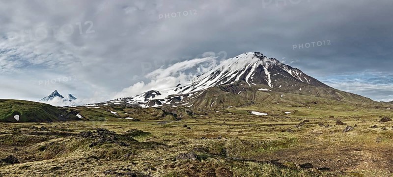 Kamchatka Peninsula beautiful mountain panorama landscape: scenery view on Oval Zimina Volcano in cloudy weather. Eurasia, Russian Far East, Kamchatka Region, Klyuchevskaya Group of Volcanoes