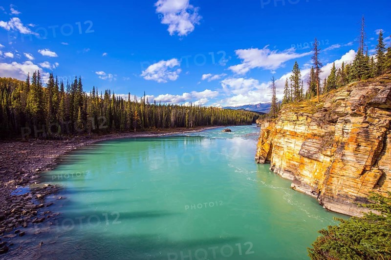 Athabasca River in the Rocky Mountains of Canada. Magnificent landscape in Jasper Park. Indian summer. Travel and photo tourism concept