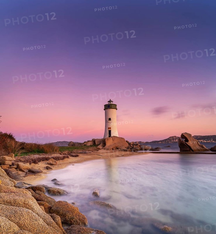 Long exposure view of the Punta Palau Lighthouse on the Emerald Coast of Sardinia at sunrise