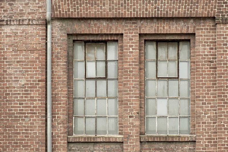 Details of an old industrial building, brick wall and windows, approx. 100 years old