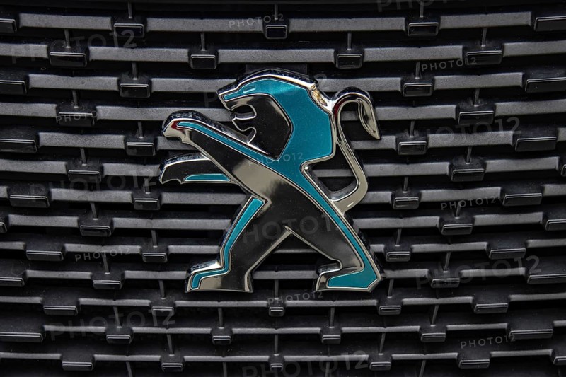 WETZLAR, Germany 2022-04-23: Peugeot logo closeup on a car grill. Peugeot as car manufacturer was founded at 1882