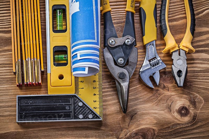 Variation of construction tools on vintage wooden board