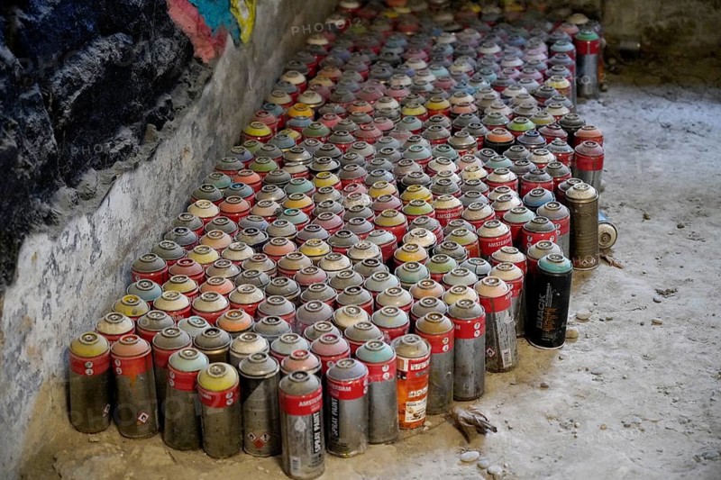 MAUSA VAUBAN, Museum of Urban Art and Street Art, Neuf-Brisach Fortress, France, Europe, A large collection of colourful spray cans neatly arranged on the floor of an abandoned place