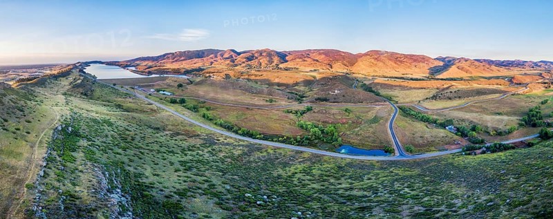 Aerial panorama of foothills near Fort Collins, Colorado with Horsetooth Reservoir, Lory State Park, Charles Hansen Canal and Centennial Road, sunrise at late summer