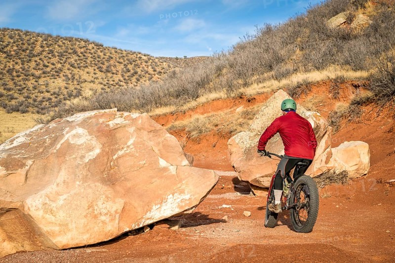 Riding a fat bike on mountain desert trail in Red Mountain Open Space in northern Colorado, late fall scenery