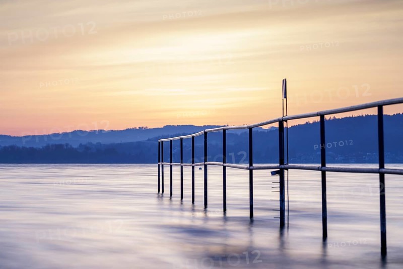 Twilight over the lake with railing, soft sky and calm atmosphere, lido, Litzelstetten, Lake Constance, Baden-Württemberg, Germany
