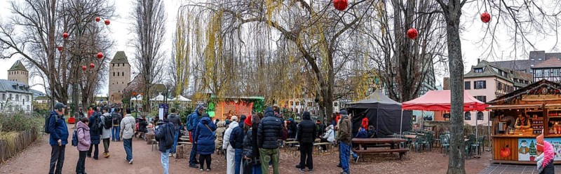 Panoramic photo Christmas market on the Louise-Weiss island square in the old town and the Heinrichsturm in the background, La Petite France, Strasbourg, Alsace, Département Bas-Rhin, France