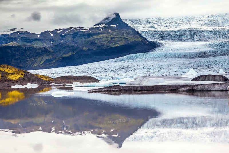 Glacier meltwater form a picturesque lake. The sunset over the Iceland's largest glacier Vatnajokull. The concept of extreme northern tourism