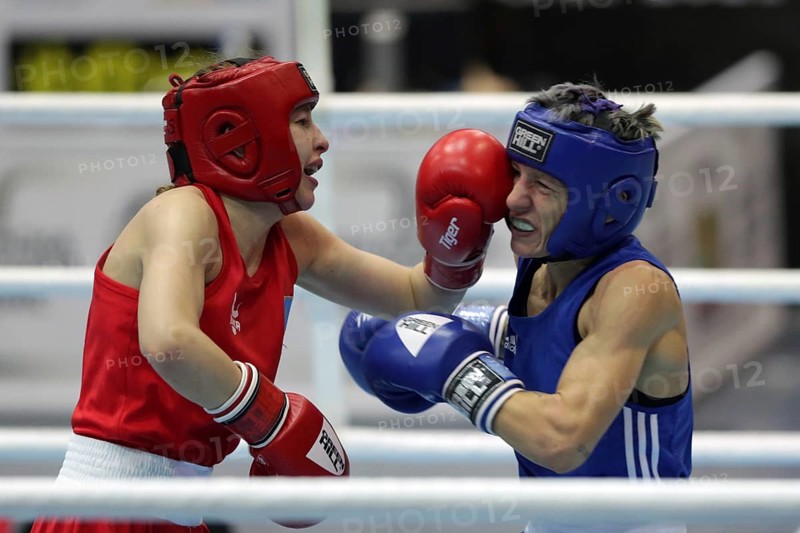 Sofia, Bulgaria - 26 February, 2021: Angelina Lukas (red) of Kazakhstan and Lacramioara Perijoc of Romania fight in their semifinal round of Fly (W51kg) category of the 72-nd International Boxing Tournament Strandja 2021, Sofia, Bulgaria