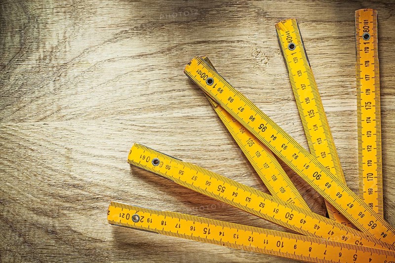 Wooden meter on wood board construction concept