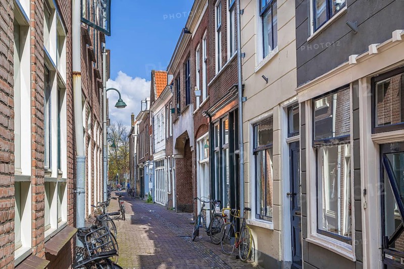 Street with historical houses in Delft downtown, Netherlands