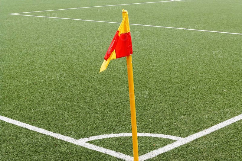 Corner of a ball soccer field wwith pile and flag