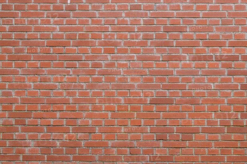 Bricks in an orange-red color in chain linked regulation to an old building in the Netherlands