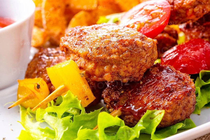 Meatballs skewers of tomato, paprika and baked potato quarters
