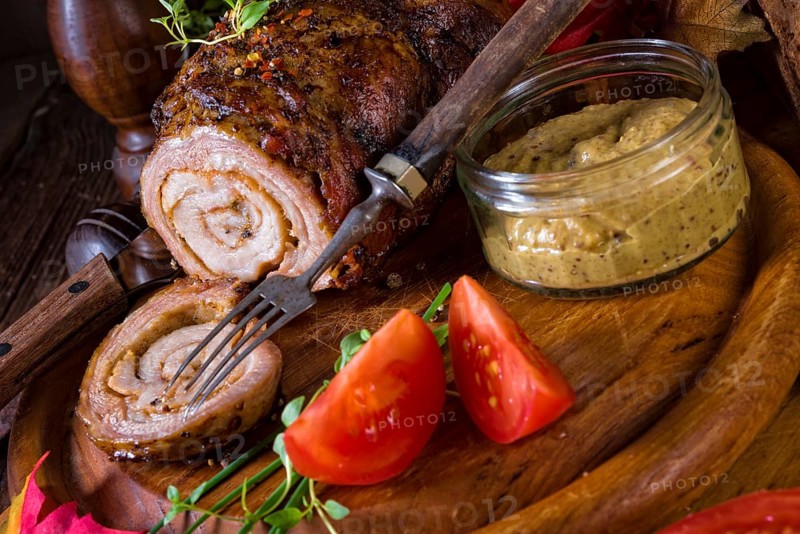 Rolling roasts fullly with dried fruit and bacon