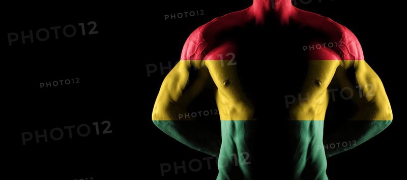 Ghana flag on muscled male torso with abs, black background