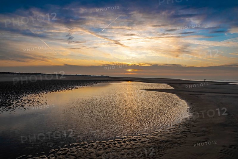 Sunset over the North beach of Borkum with beautiful sky