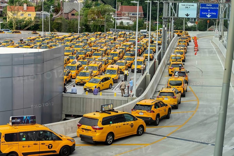 Yellow taxi cabs wait in line at LaGuardia Airport before picking up their fares